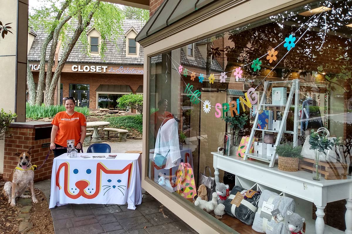 HSTV staff table by Spa 9700 storefront with Arlo the dog ambassador